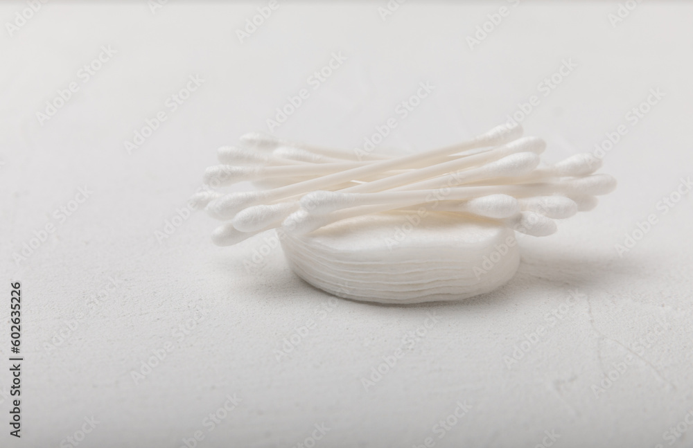 Cotton buds on a textured cement background. Cotton swab on a white background. Sticks for hygiene of the nose and ears. Plastic cotton swabs. Cotton wool. Space for text.Space for copy. Cotton buds on a textured cement background. Cotton swab on a white background. Sticks for hygiene of the nose and ears. Plastic cotton swabs. Cotton wool. Space for text.Space for copy.