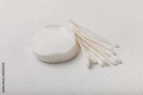 Cotton buds on a textured cement background. Cotton swab on a white background. Sticks for hygiene of the nose and ears. Plastic cotton swabs. Cotton wool. Space for text.Space for copy.
