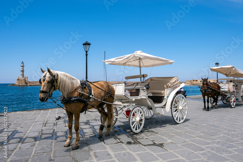 Horse and carriages at the old venetian harbour of Chania, Crete, Greece. © Jim