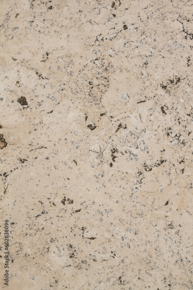 The texture of the stone is notched and mottled. holes notches grooves on the stone.