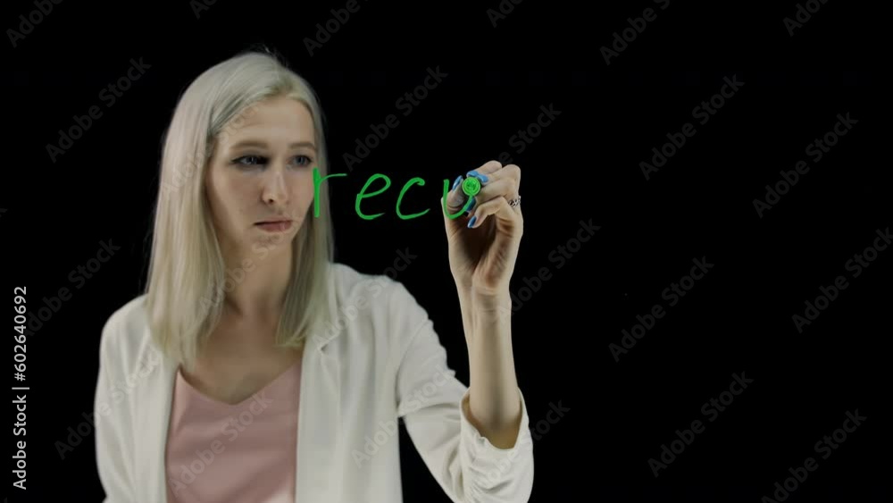 Recycle on a black background. Inscription in green marker on a transparent surface. Handwritten text. Recycle on a black background. Inscription in green marker on a transparent surface. Handwritten text.