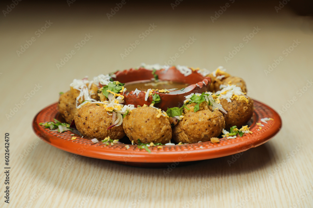 Fuchka or pani puri and gol gappay with sour water, served in dish isolated on table top view of indian, bangladeshi and pakistani street food - obrazy, fototapety, plakaty 