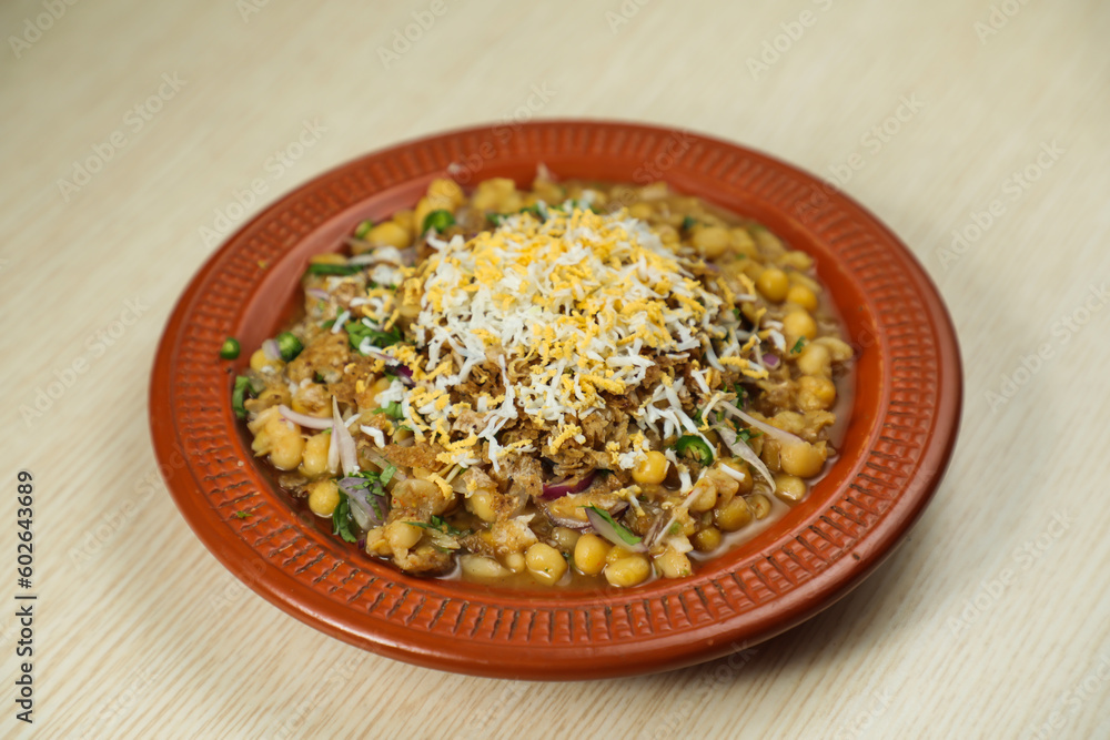 Spicy chotpot masla chaat with chana, chola, chilli served in dish isolated on table top view of indian, bangladeshi and pakistani street food Spicy chotpot masla chaat with chana, chola, chilli served in dish isolated on table top view of indian, bangladeshi and pakistani street food