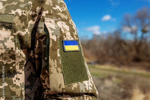 Armed Forces of Ukraine. Ukrainian soldier. Ukrainian flag on military uniform. photo