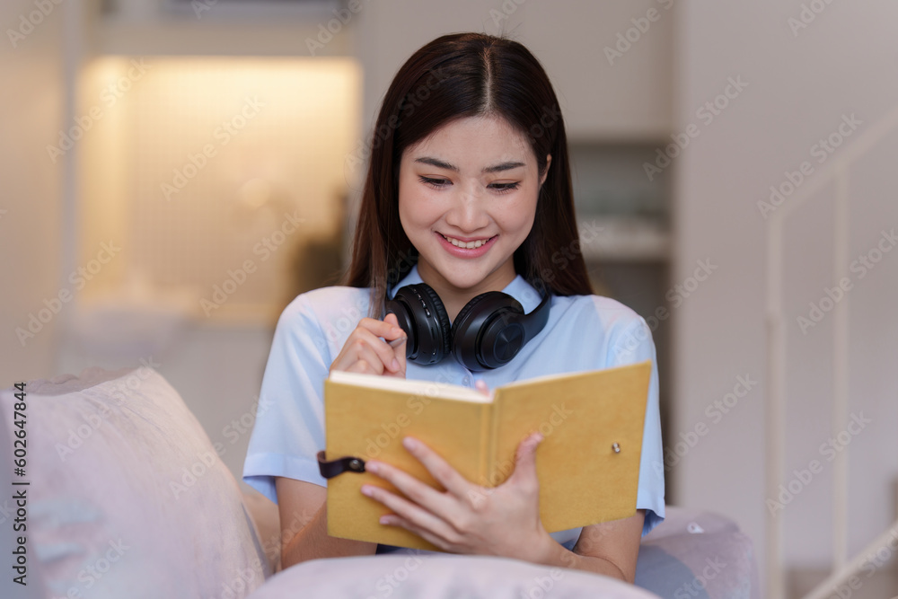 Attractive Asian woman resting comfortable living room and reading book, Relax, Sofa, Lifestyle Attractive Asian woman resting comfortable living room and reading book, Relax, Sofa, Lifestyle