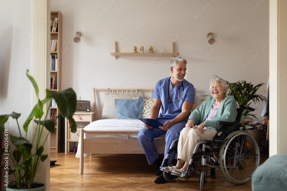 Caregiver doing regular check-up of senior woman in her home. - obrazy, fototapety, plakaty 