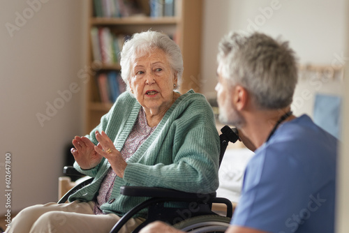 Caregiver doing regular check-up of senior woman in her home.