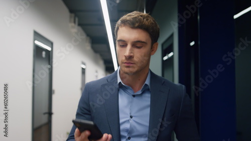 Closeup entrepreneur making call in office. Successful executive leaving room