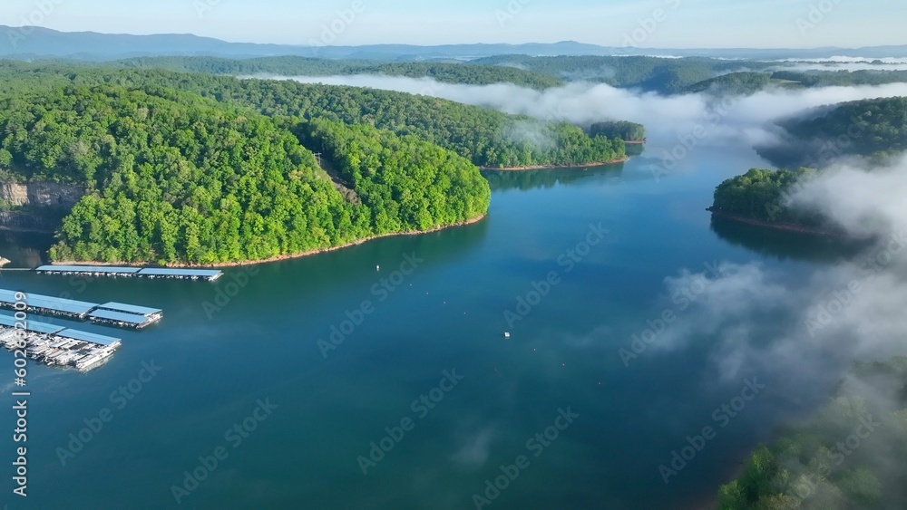 Landscape with lake beneath morning clouds and fog in mountains of Tennessee near Rocky Top at Norris Dam