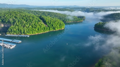Landscape with lake beneath morning clouds and fog in mountains of Tennessee near Rocky Top at Norris Dam