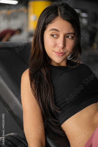 seductive look of latin woman with black hair, wears comfortable sporty clothes, female model with healthy lifestyle, people portrait