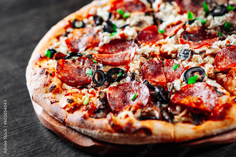 Pepperoni Pizza with Mozzarella cheese, salami, Tomato sauce, pepper, Spices. Italian pizza on wooden table background Pepperoni Pizza with Mozzarella cheese, salami, Tomato sauce, pepper, Spices. Italian pizza on wooden table background