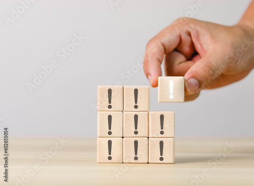 wooden block showing black exclamation mark warning error notice maintenance and finding solutions white background