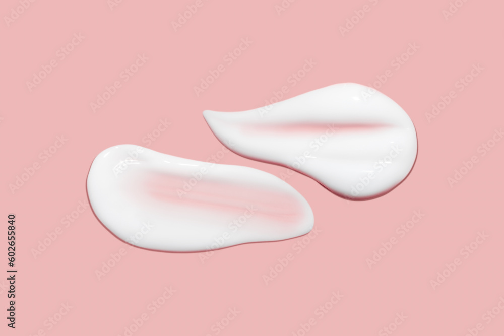 Lots of smears of cosmetic cream. Light, smooth surface. Texture of spreadable cream. Liquid creamy strokes. On a pink background. Cosmetic background, banner. Lots of smears of cosmetic cream. Light, smooth surface. Texture of spreadable cream. Liquid creamy strokes. On a pink background. Cosmetic background, banner.