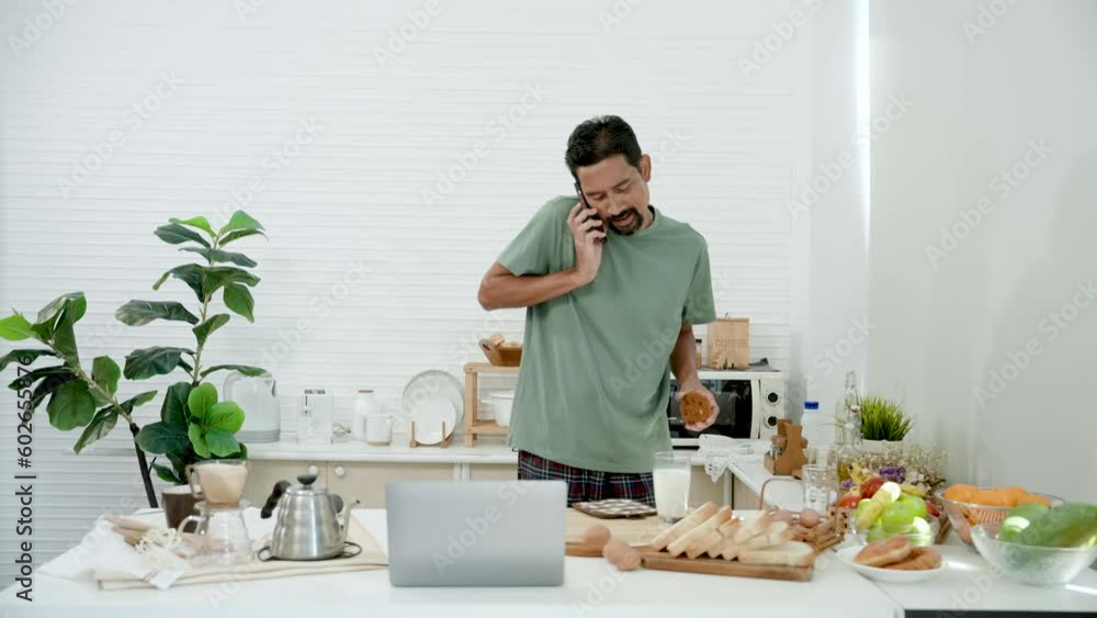Asian man in casual clothes on vacation at home, was walking talking on phone, walked into kitchen, put phone flat ear use both hands pick up glass milk cookies eat, walked out kitchen. Asian man in casual clothes on vacation at home, was walking talking on phone, walked into kitchen, put phone flat ear use both hands pick up glass milk cookies eat, walked out kitchen.