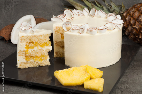 pineapple coconut cake with coconut liqueur on a dark background