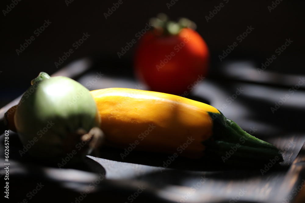 three different vegetables on a wooden plate isolated