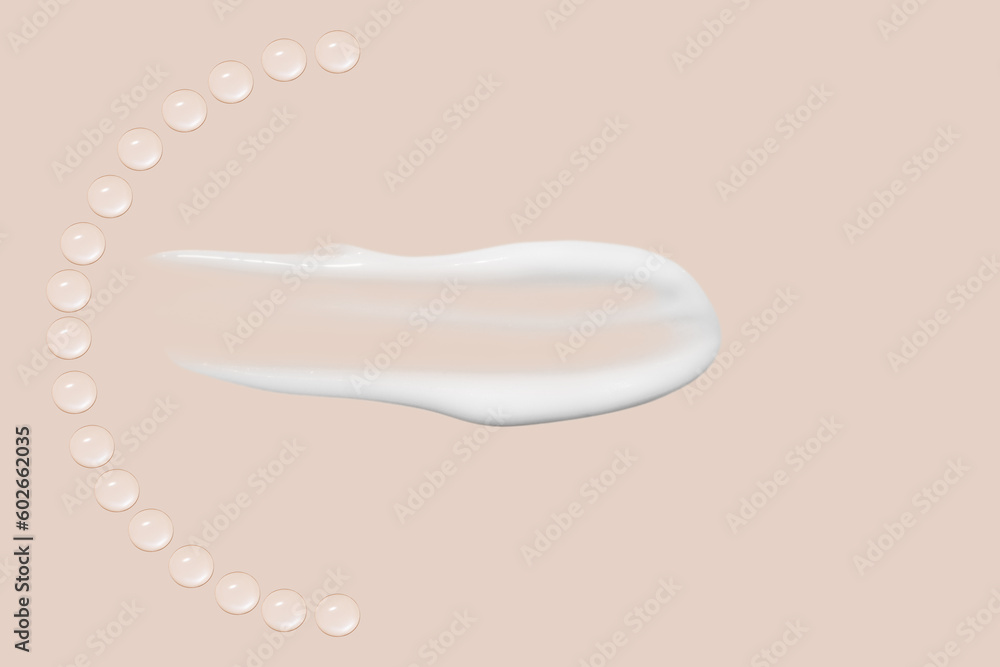 Drops of transparent gel and a dab of white cosmetic cream. On a beige background. Drops of transparent gel and a dab of white cosmetic cream. On a beige background.