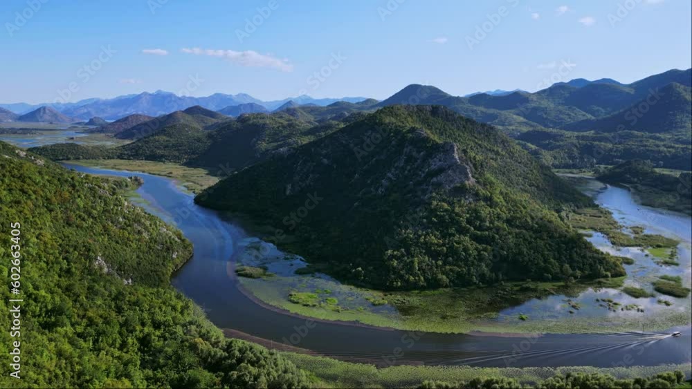 Drone flight over the bend of the Rijeka Crnojevica river near Lake Skadar while fishing from a moving boat. River between the mountains in Montenegro. 4K epic drone footage, montenegro mountains, Drone flight over the bend of the Rijeka Crnojevica river near Lake Skadar while fishing from a moving boat. River between the mountains in Montenegro. 4K epic drone footage, montenegro mountains,