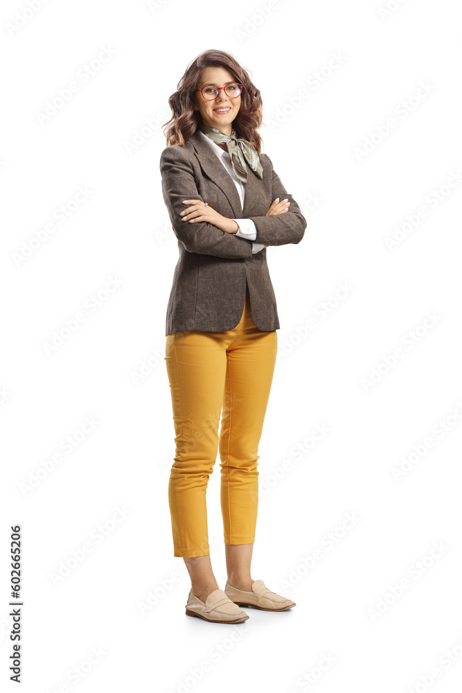 Full length shot of a young woman standing with folded arms and smiling Full length shot of a young woman standing with folded arms and smiling