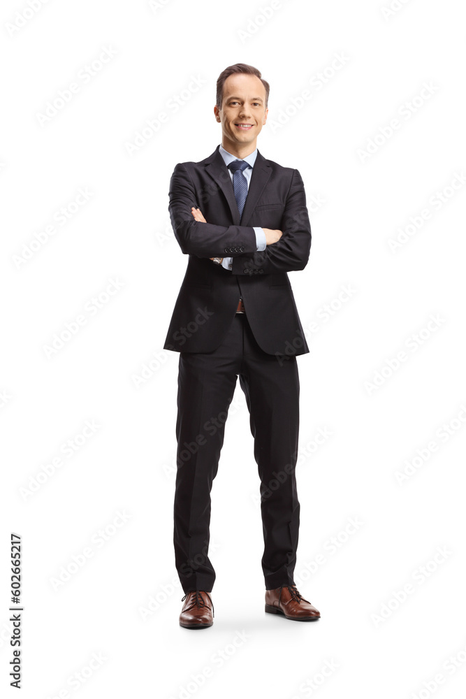 Full length portrait of a businessman standing with folded arms and smiling Full length portrait of a businessman standing with folded arms and smiling