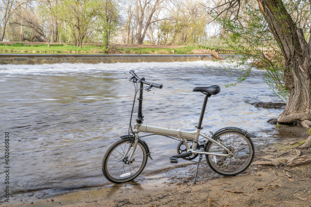 lightweight folding bike on a shore of the Poudre River in Fort Collins, Colorado, spring scenery