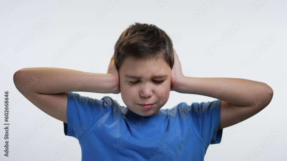 Boy closes ears with his hands Boy closes ears with his hands