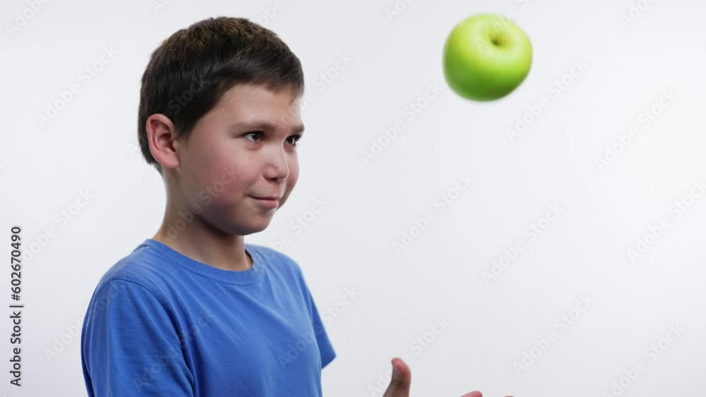 Boy throws an apple up Boy throws an apple up