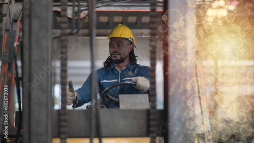 African male worker working in warehouse goods store. inventory staff moving product pallet shipping management with folk lift truck.