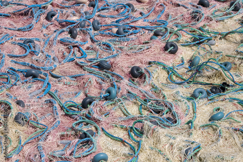 Mixture of colorful fishing nets, floats and ropes. Fisherman material background. © AliRza