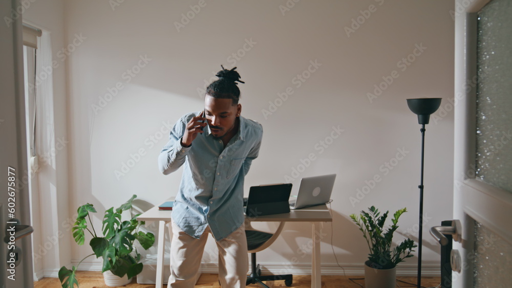 Angry guy talking smartphone home office. Annoyed man arguing having disagree Angry guy talking smartphone home office. Annoyed man arguing having disagree