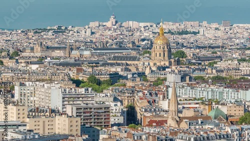 Aerial panorama above houses rooftops in a Paris timelapse. Evening view with les invalides dome bebore sunset photo