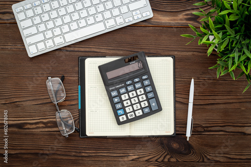 Business accounter working place with taxes and calculator photo