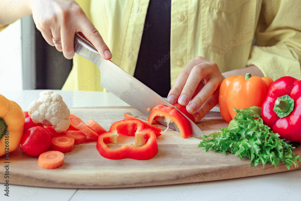 cut fresh vegetables with a knife, a woman uses a knife and cooks cut fresh vegetables with a knife, a woman uses a knife and cooks