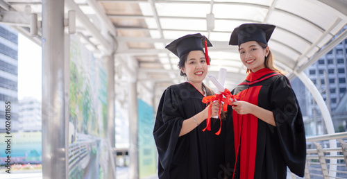 Happy student graduate hand holding diplomas and gold prize coins.