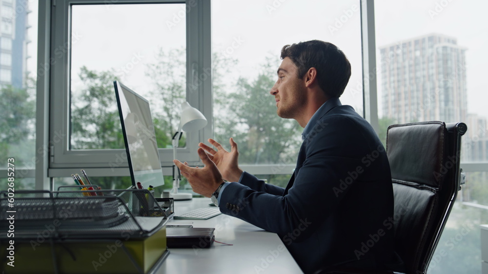 Handsome freelancer talking online at remote workplace. Office manager calling Handsome freelancer talking online at remote workplace. Office manager calling