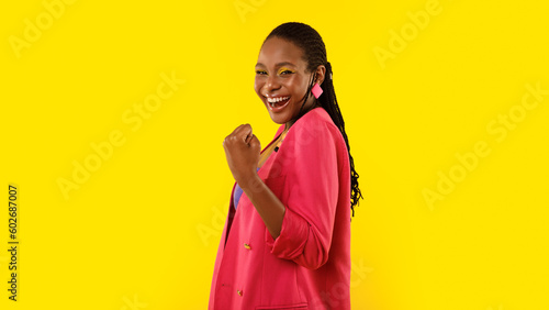 Glad African Woman Gesturing Yes With One Hand, Yellow Background