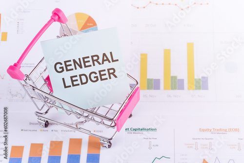 GENERAL LEDGER text on the white paper on light background with charts paper