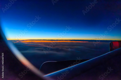 view from an aircraft window to the sunrise
