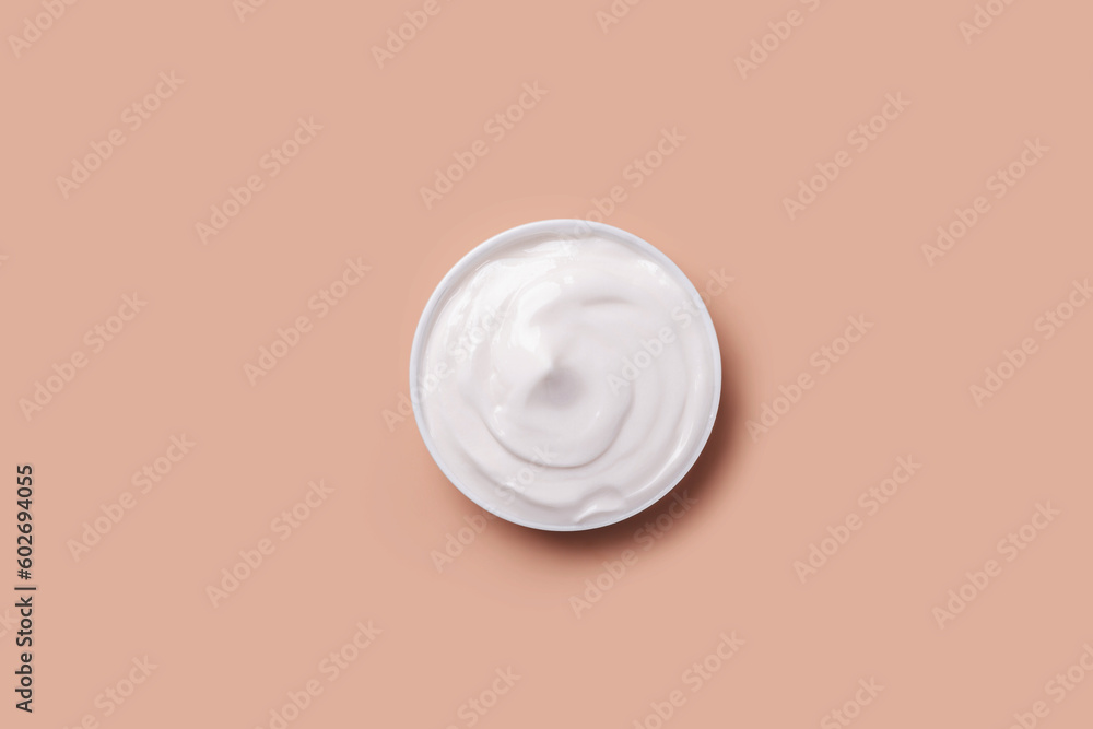 Cream jar of white on a beige background. Cream jar of white on a beige background.