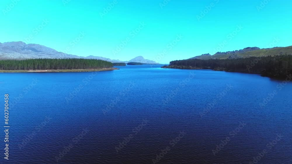 Nature, drone and environment with lake at countryside for peace, landscape and travel in Norway. Water, mountains and forest park on island of river with blue sky for tourism, scenic and freedom Nature, drone and environment with lake at countryside for peace, landscape and travel in Norway. Water, mountains and forest park on island of river with blue sky for tourism, scenic and freedom