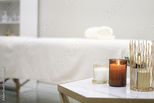 Place for relaxation in modern wellness center. candle towels massage table