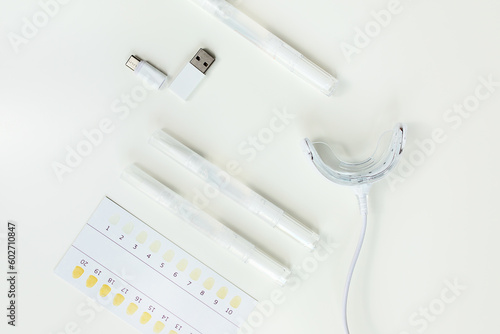 teeth whitening kit at home with LED lamp, on a white background, snow-white smile, dental care, dentistry
