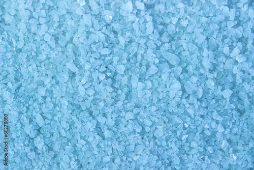 Small blue crystals as background. Texture of red crystals