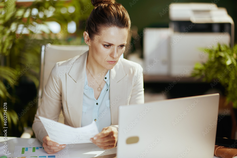 pensive 40 years old business owner woman in green office pensive 40 years old business owner woman in green office