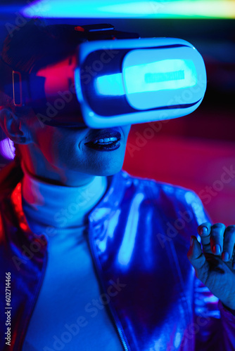 happy elegant woman in virtual reality goggles in office