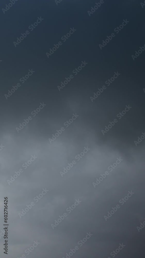 The dreary weather matches the somber mood, as gray clouds obscure the sun. A video timelapse captures the melancholic charm of a rainy sky. Vertical video. The dreary weather matches the somber mood, as gray clouds obscure the sun. A video timelapse captures the melancholic charm of a rainy sky. Vertical video.