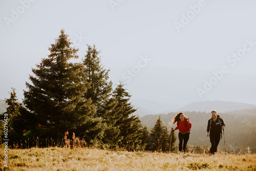 Smiling couple walking with...