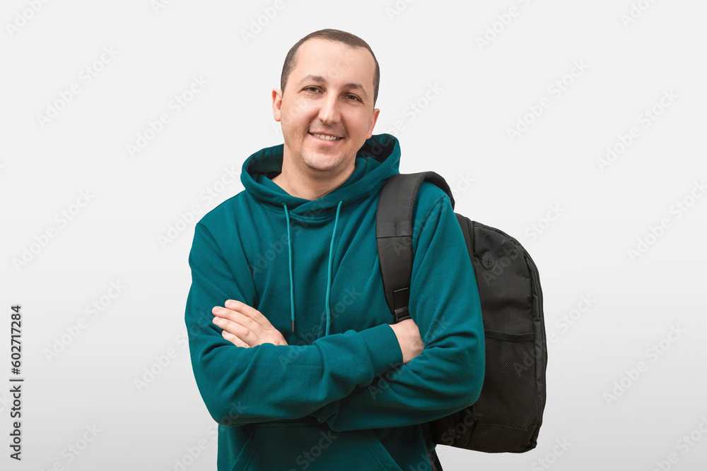 Portrait of a smiling young man with a backpack on a white background. Portrait of a smiling young man with a backpack on a white background.