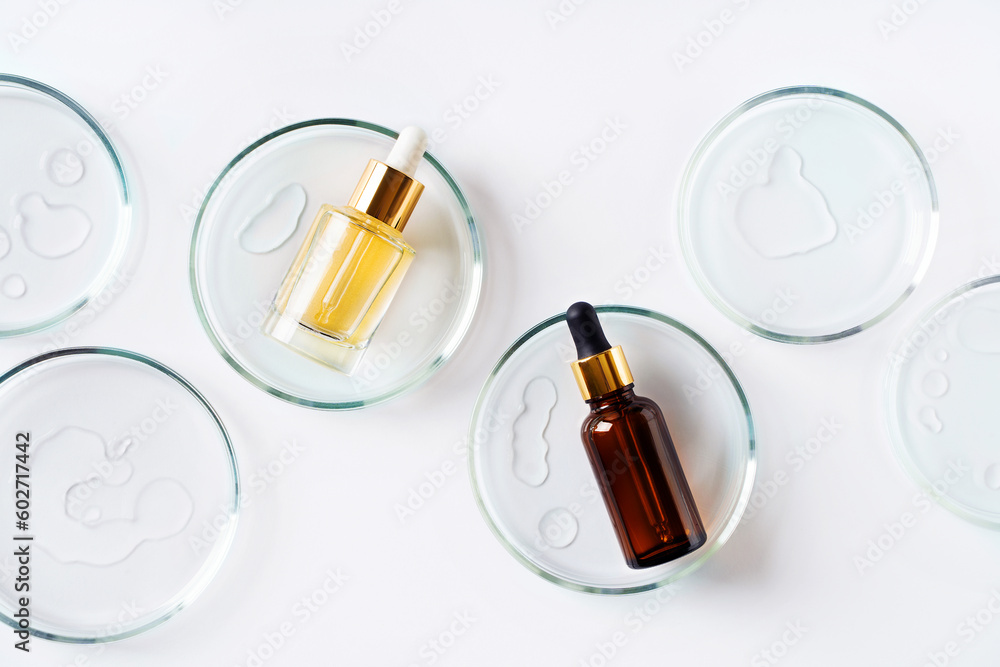 Cosmetic beauty concept with bottle serum, drops and petri dish on white background
